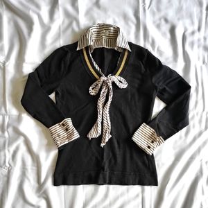 Long sleeve black shirt with white collar and ribbon